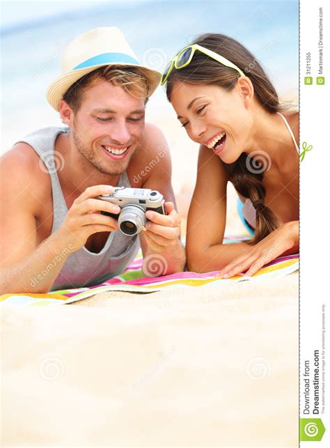 Happy Couple Fun On Beach Looking At Camera Royalty Free