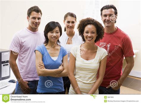 people standing  computer room smiling stock image image