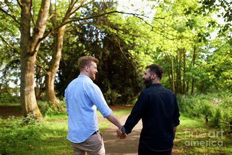 Affectionate Male Gay Couple Holding Hands Photograph By Caia Image