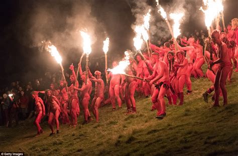 naked revellers brandish flaming torches daily mail online