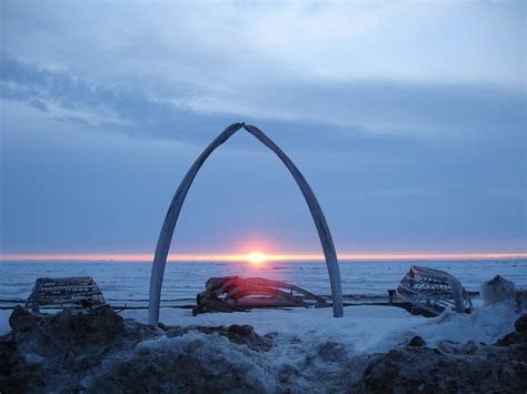 barrow ak midnight sun through the famous whalebone arch outside