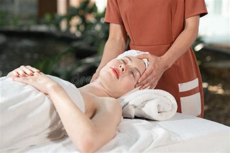 Beautiful Young Woman Receiving Head Massage Relaxing In Spa Salon