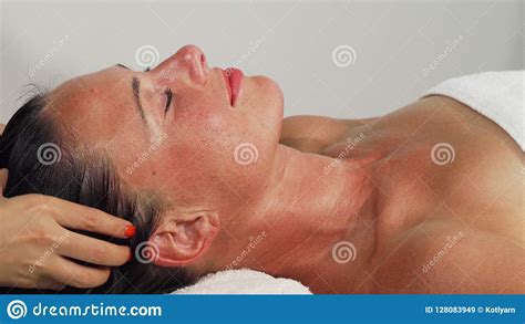Happy Beautiful Mature Woman Smiling While Getting Head Massage Stock