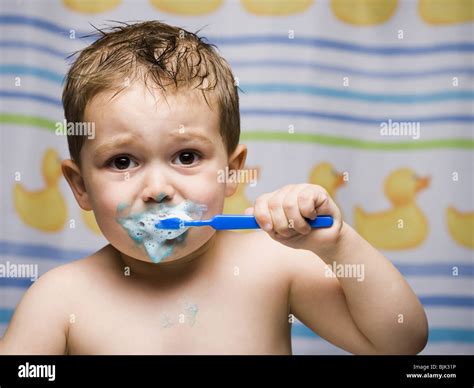 boy brushing teeth  bathroom stock photo alamy