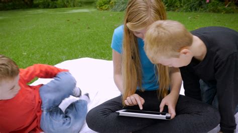 older sister shows   younger brothers    tablet