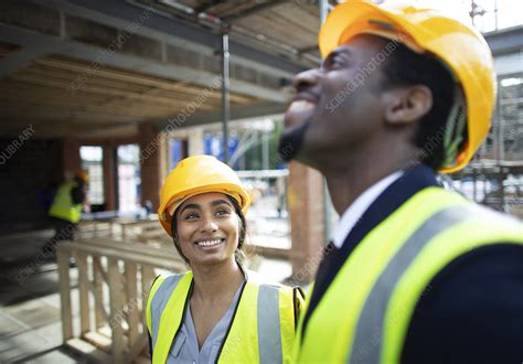 happy construction workers talking  construction site stock image  science