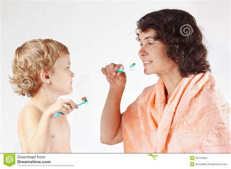 mother teaches her little son to brush their teeth stock images image 26175904