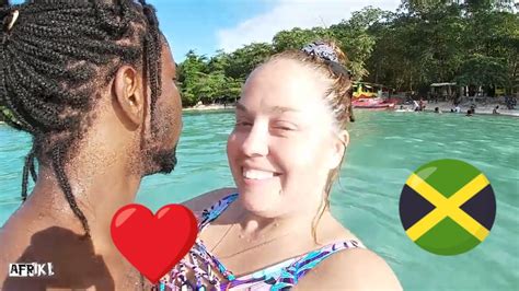jamaican beach packed with people winifred beach interracial couple