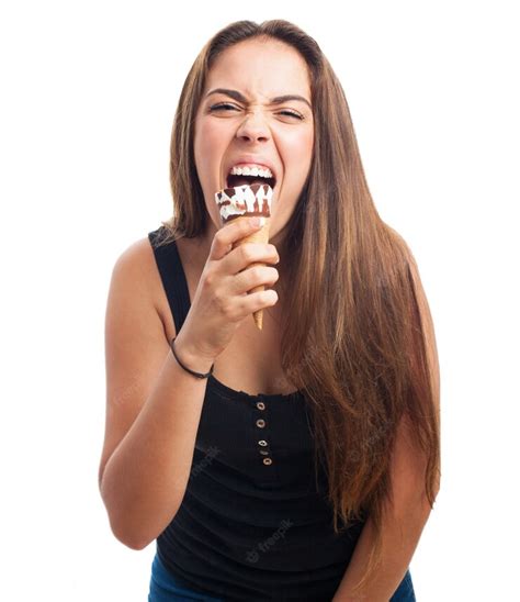 free photo hungry brunette girl biting cone ice cream