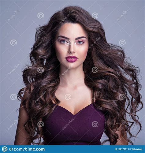 Face Of A Beautiful Woman With Long Brown Curly Hair Fashion Model
