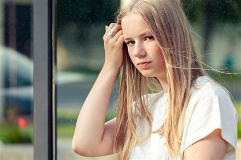 Outdoors Portrait Of 15 Year Old Blonde Teen Girl With Long Hair In