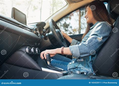 A Female Driver Shifting Automatic Gear Stick While Driving Car Stock