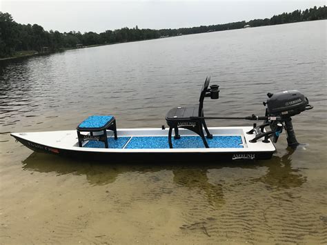 small boat   seats     sitting  shallow water    outboard motor