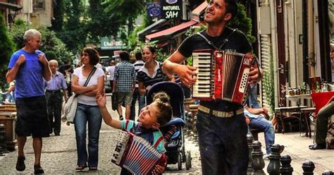 Nonchalant Accordion Players And A Guy Wearing An Invisible Backpack