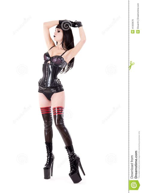 dominant woman in latex costume and high heel shoes stock