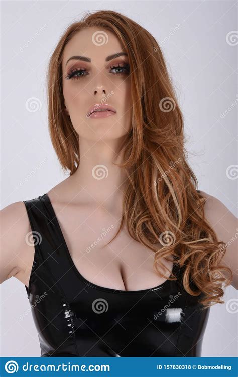 Sexy Busty Redhead In Short Tight Latex Dresses Stock