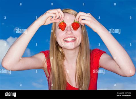 woman holding strawberries  eyes stock photo alamy