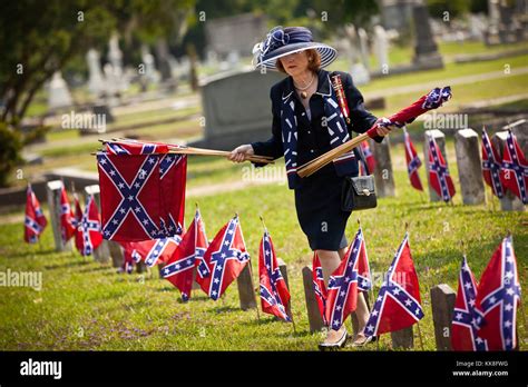 a member of the daughters of the confederacy removes confederate flags