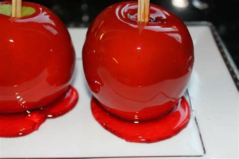red apples  toothpicks sticking      white square plate