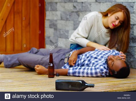 Man Wearing Casual Clothes Lying Drunk Passed Out On Wooden Surface