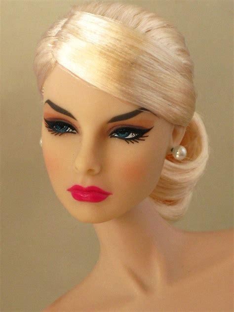 A Mannequin Head With Blonde Hair And Bright Pink Lipstick On It S Face