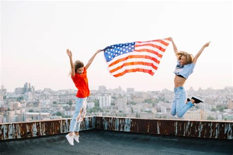 Independence Day Concept With Joyful Girls On Rooftop