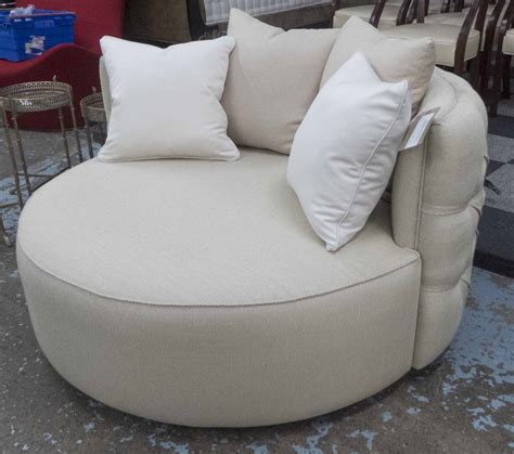 sofa   beige fabric external buttoned    ebonised swivel support cm diam