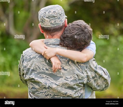 shot   father returning   army hugging  son  stock