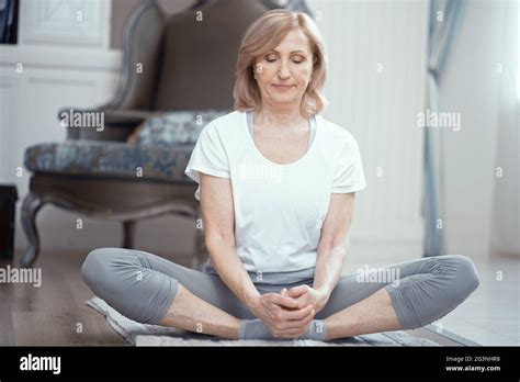 woman  sitting  crossed legs yoga pose stock photo alamy