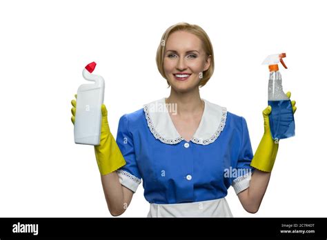 blonde maid in yellow rubber gloves holding cleaner spray and toilet