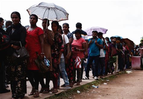 crisis hit sri lankans seek passport    life