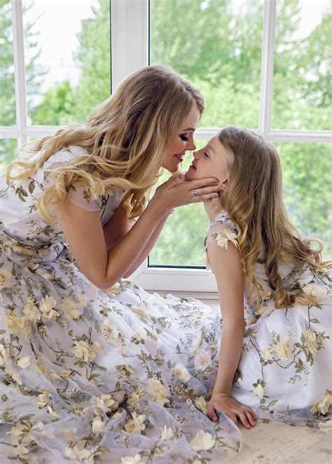 mother kissing daughter in matching dresses greeting card for sale by