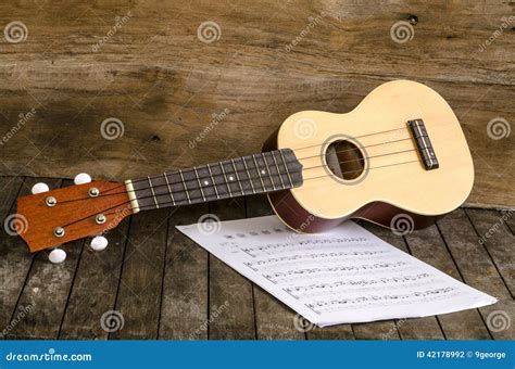 ukulele  paper chordschart document  wooden background stock photo image  craft