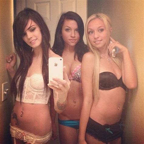 three cute teen friends taking a selfshot pic in lingerie