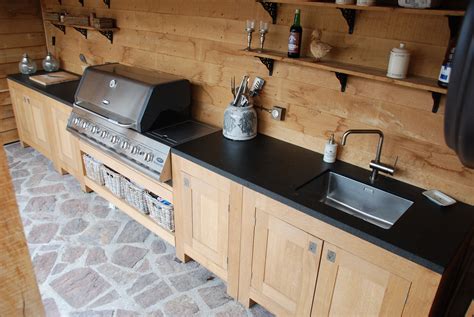 outdoor kitchen  black counter tops  wooden cabinets