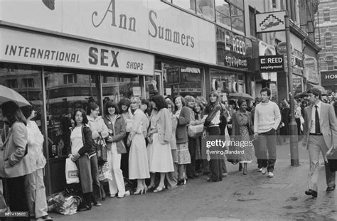 people waiting in line for the opening of an ann summers sex shop in