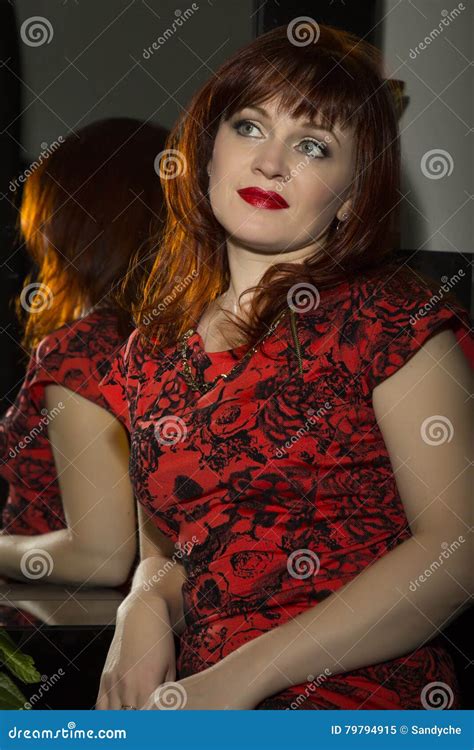 Portrait Of A Beautiful Redhead Woman Sitting Near Mirror Stock Image