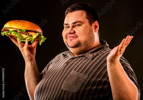man eating fast food hamberger fat person cooked terrific cheeseburger