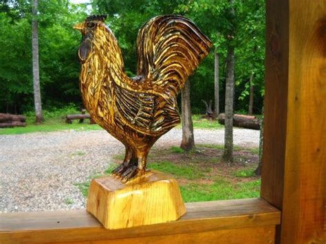 hand  rustic rooster chainsaw sculpture  sleepy