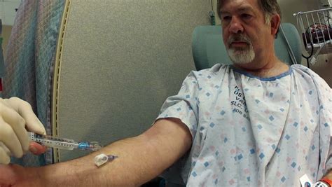 patient inserts an intravenous catheter put into his arm