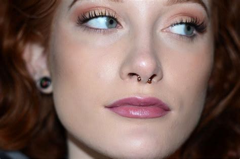 close    woman  red hair  blue eyes wearing nose piercings