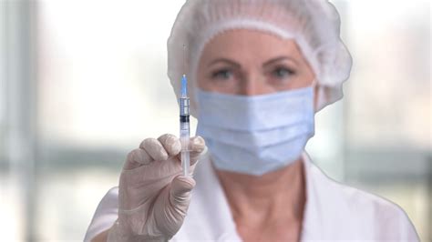 Woman Doctor Preparing Syringe For Injection Female