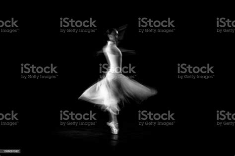 classical dancer dancing on the lack background with white dressed