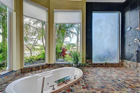 luxurious tropical bathroom that opens up the view outside [design shelly preziosi designs
