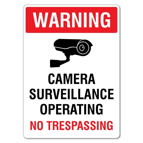 warning camera surveillance operating no trespassing sign