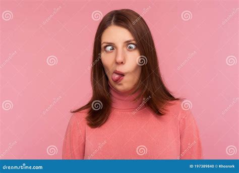 Closeup Portrait Of Funny Crazy Woman Crossing Eyes And Showing Tongue