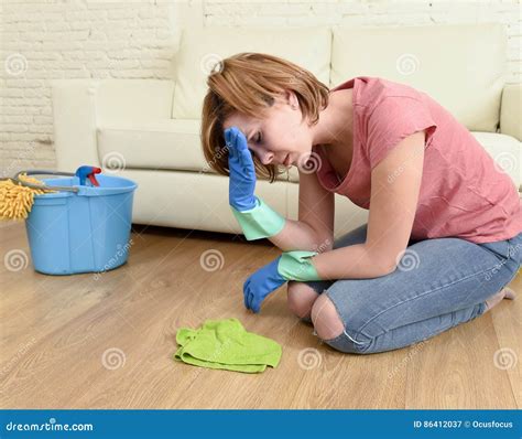 woman stressed and tired cleaning the house washing the floor on her