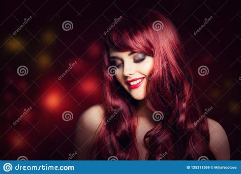 redhead woman with long red curly hairstyle stock image