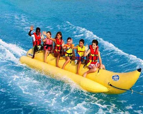 group  people riding      banana boat   ocean  life vests