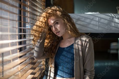 redhead with curly hair moves into college dorm stock